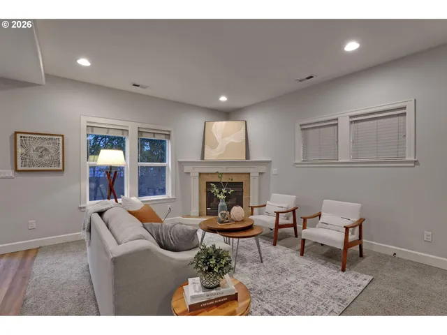 a living room with furniture and a fireplace