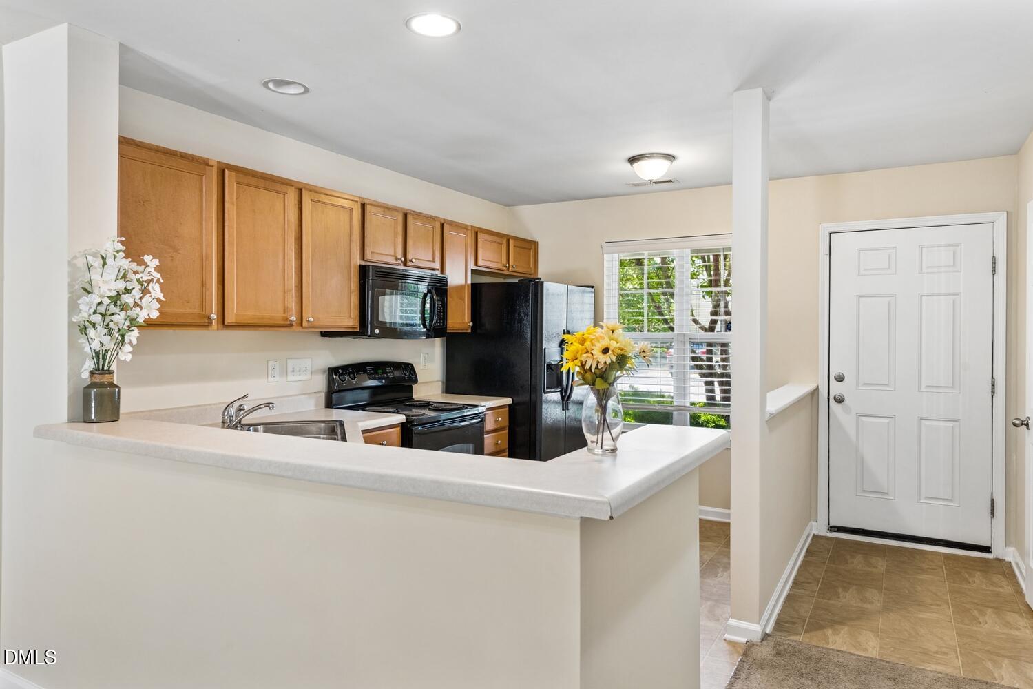 3635 Bison Hill Lane Raleigh, NC 27604 - Photo 5 of 18 a kitchen with a refrigerator and a sink