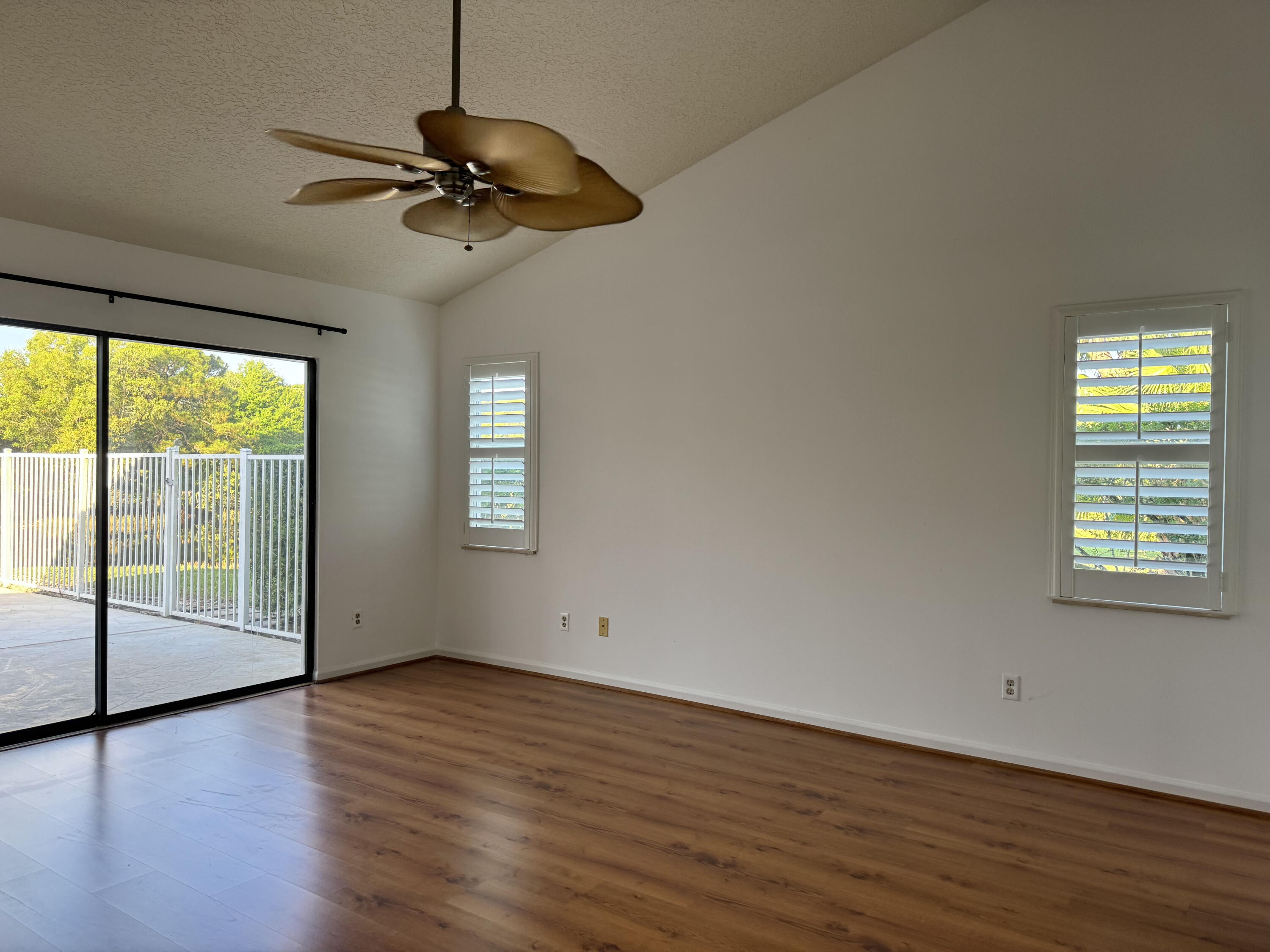 6944 Misty Lake Way Jupiter, FL 33458 - Photo 14 of 32 an empty room with wooden floor fan and windows