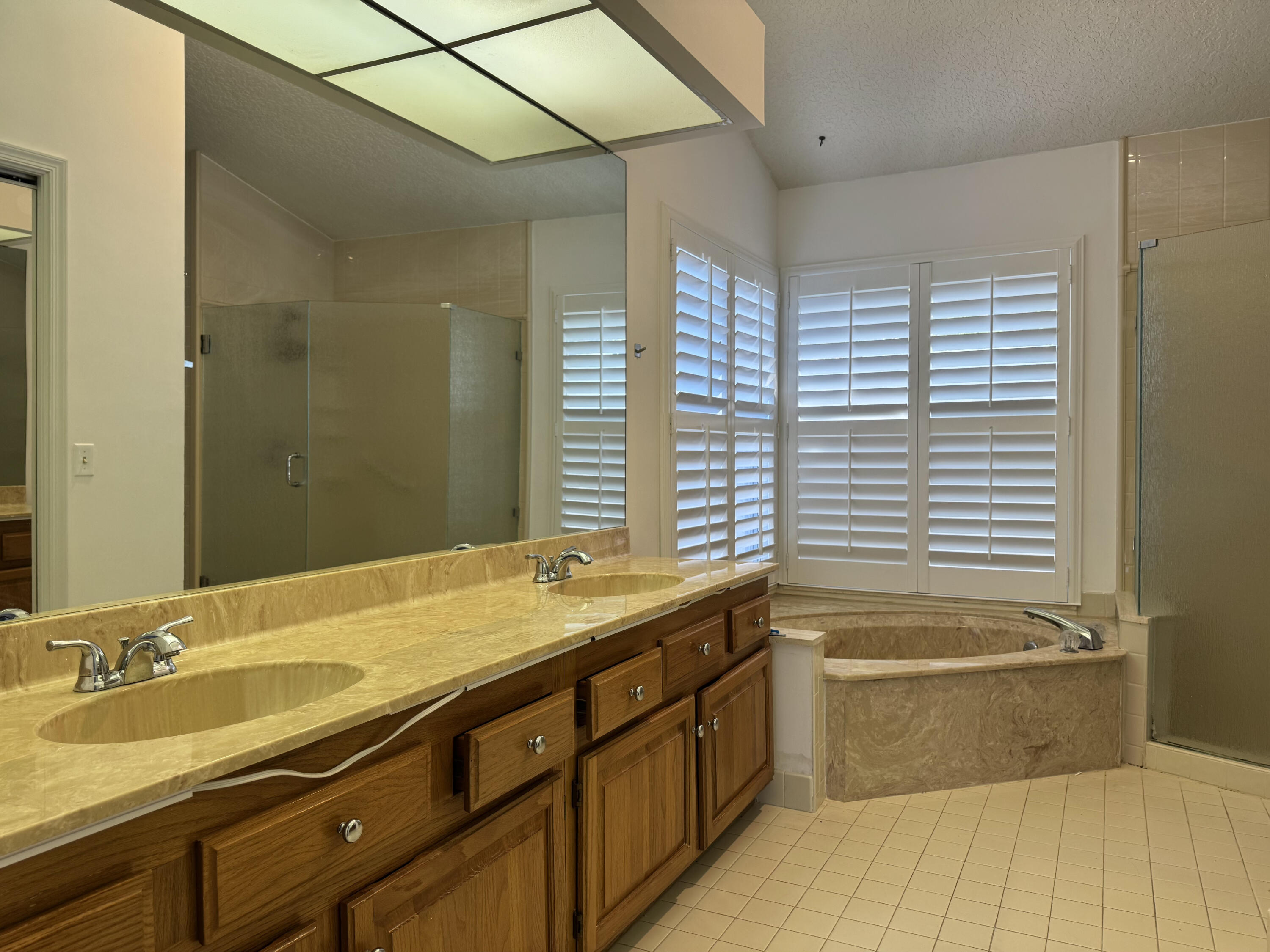 6944 Misty Lake Way Jupiter, FL 33458 - Photo 15 of 32 a bathroom with a granite countertop sink and a bathtub