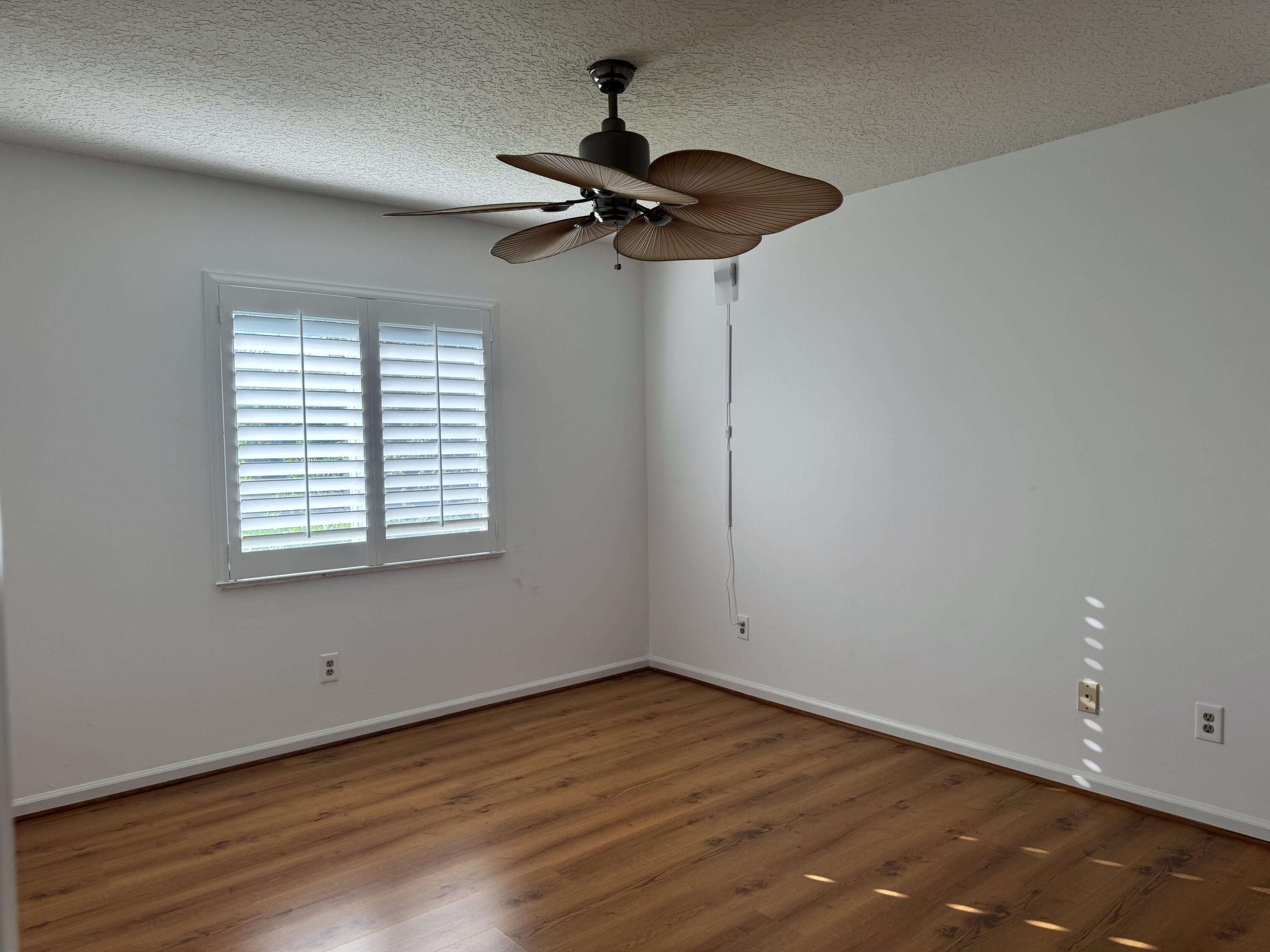 6944 Misty Lake Way Jupiter, FL 33458 - Photo 16 of 32 a view of empty room with wooden floor and fan