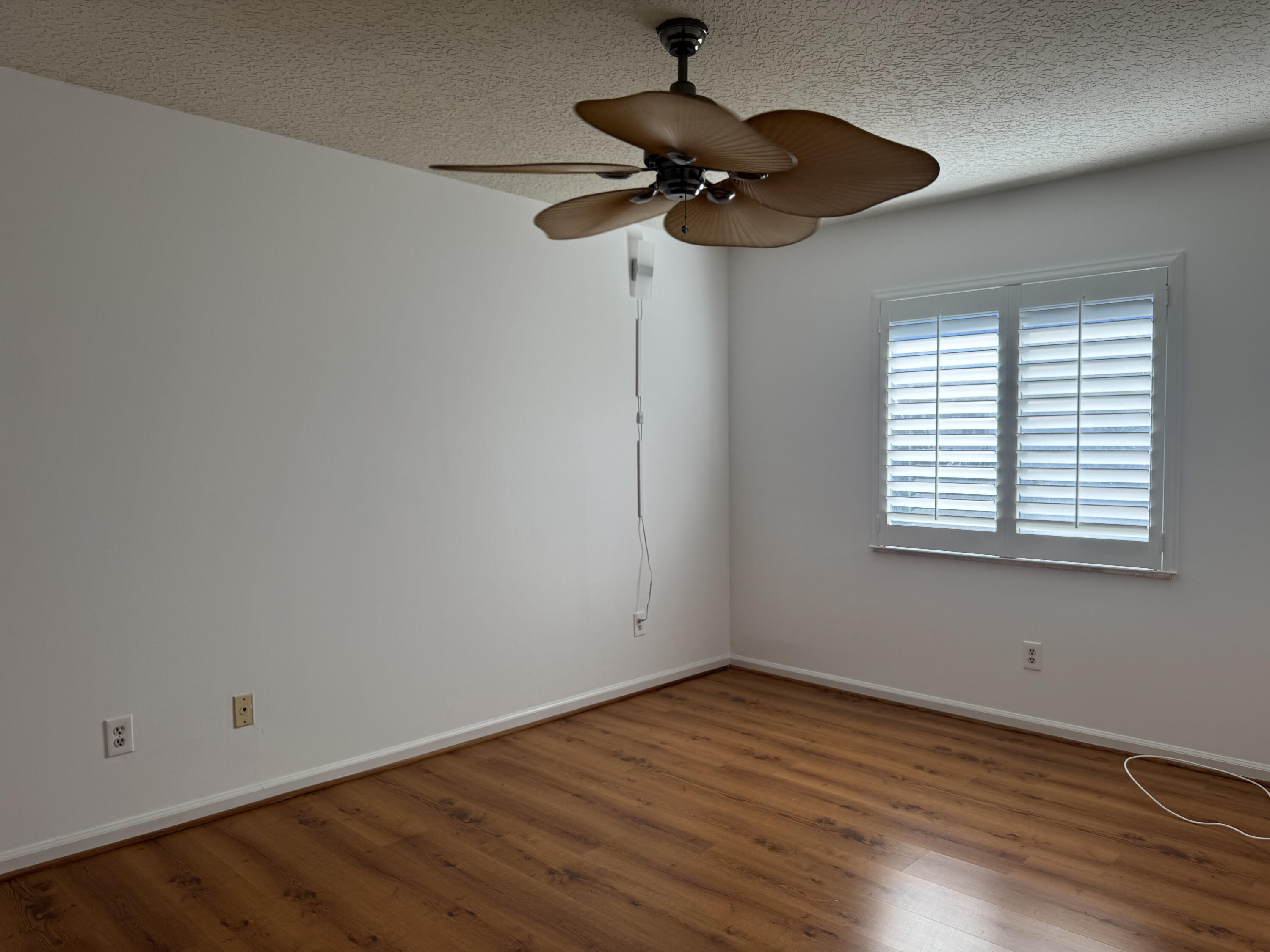 6944 Misty Lake Way Jupiter, FL 33458 - Photo 17 of 32 wooden floor in an empty room with a window