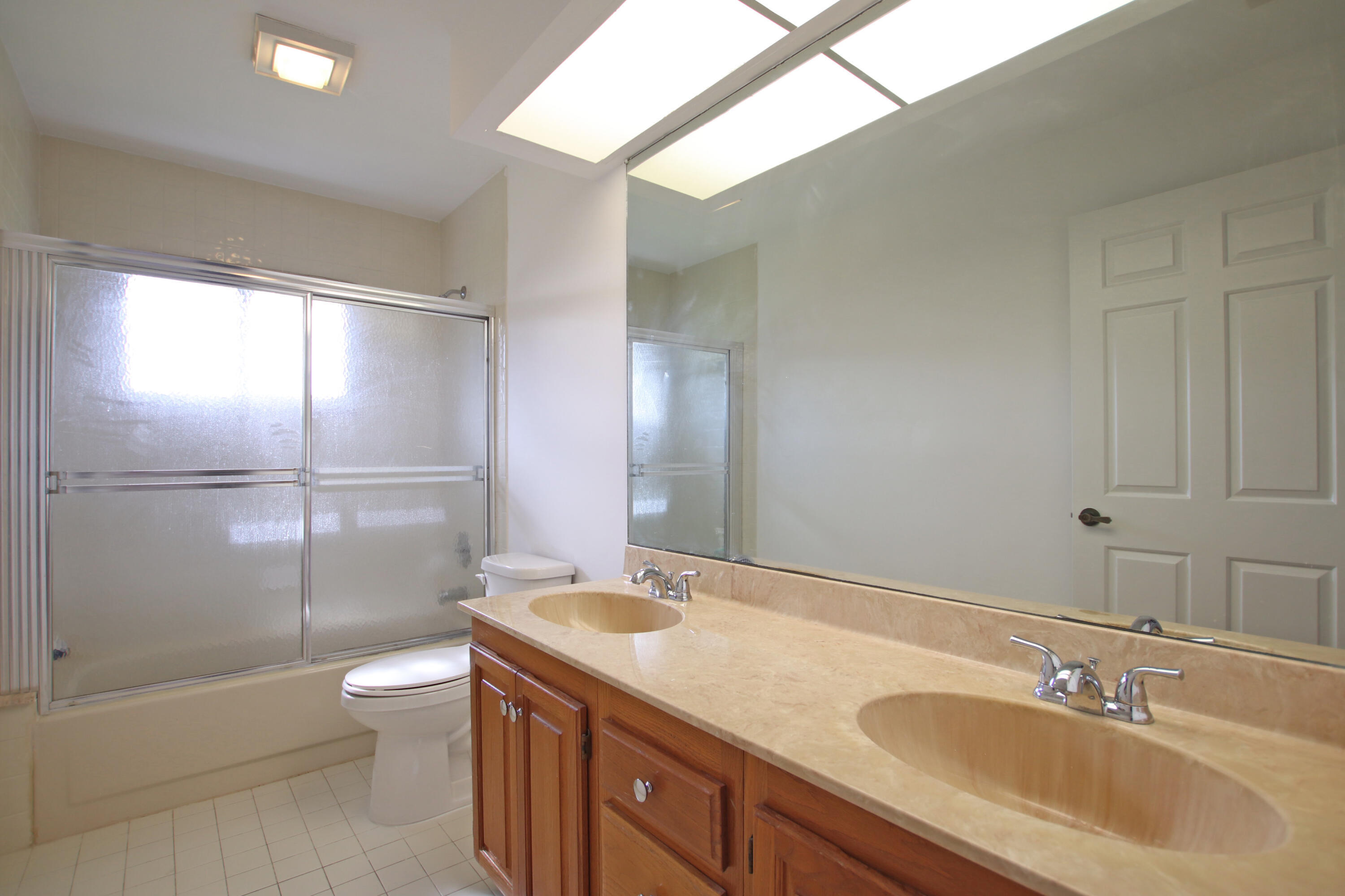 6944 Misty Lake Way Jupiter, FL 33458 - Photo 18 of 32 a bathroom with a granite countertop sink toilet and shower