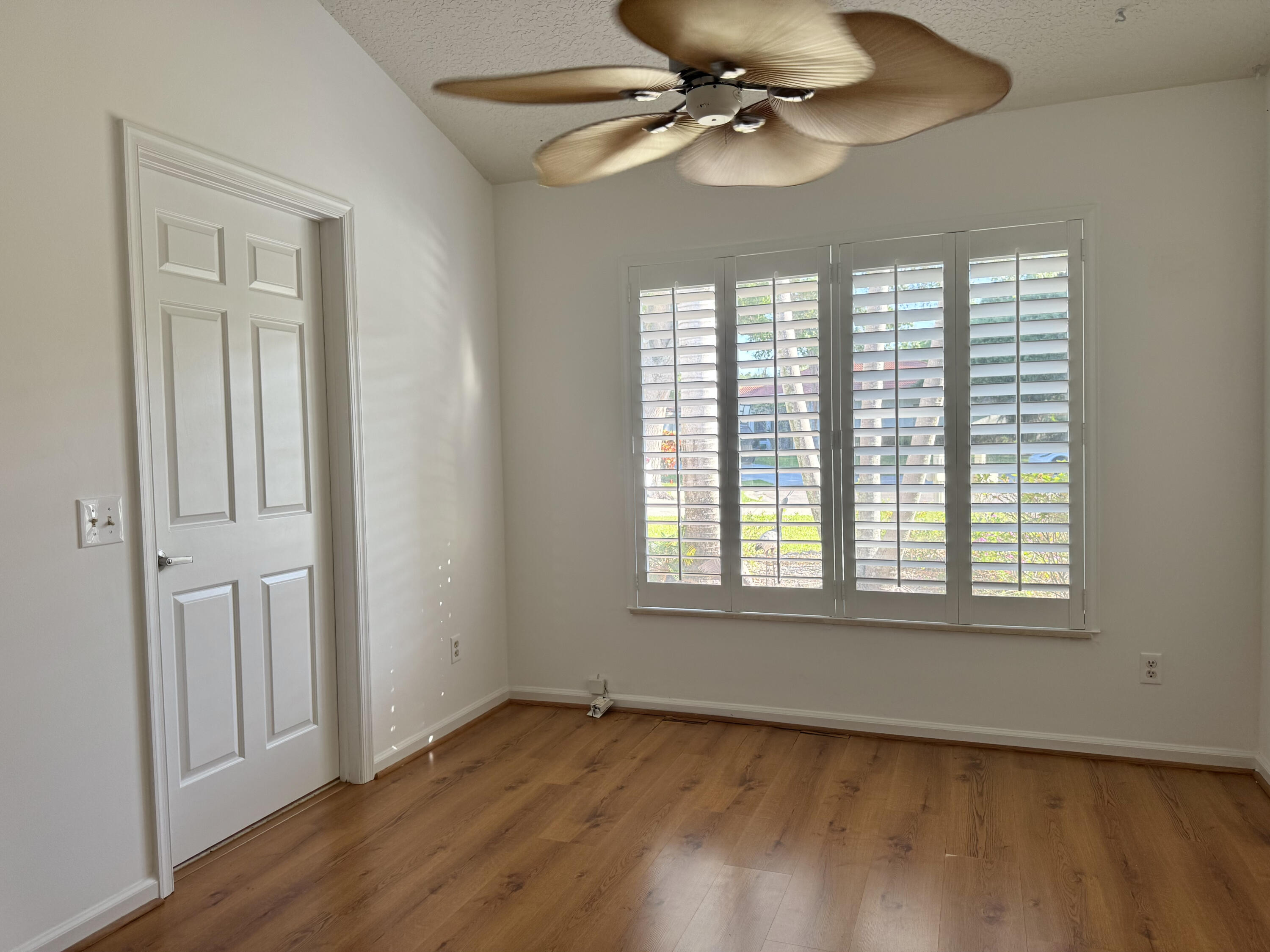 6944 Misty Lake Way Jupiter, FL 33458 - Photo 19 of 32 a view of an empty room with a window and wooden floor