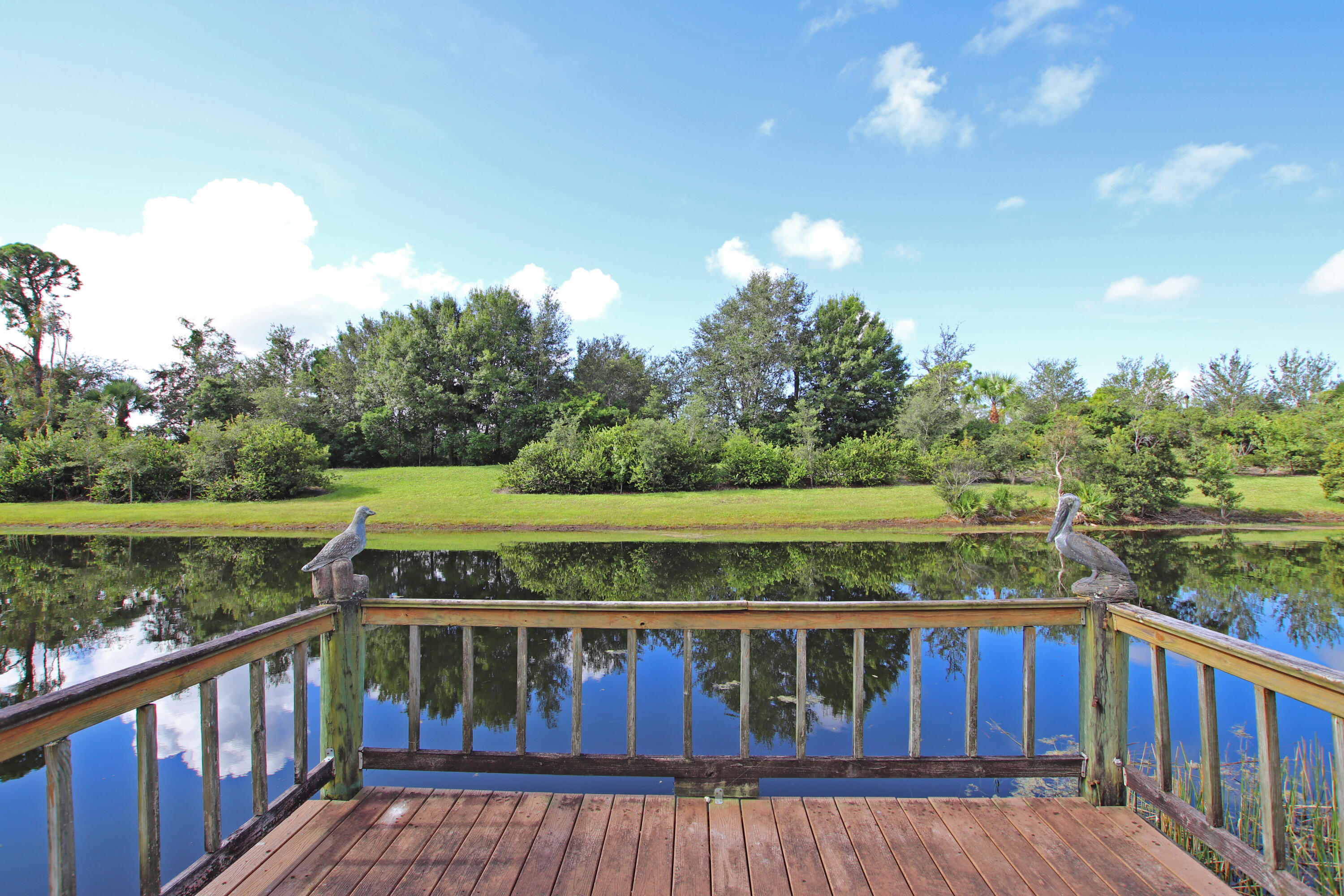 6944 Misty Lake Way Jupiter, FL 33458 - Photo 29 of 32 a view of a balcony with wooden floor and lake view