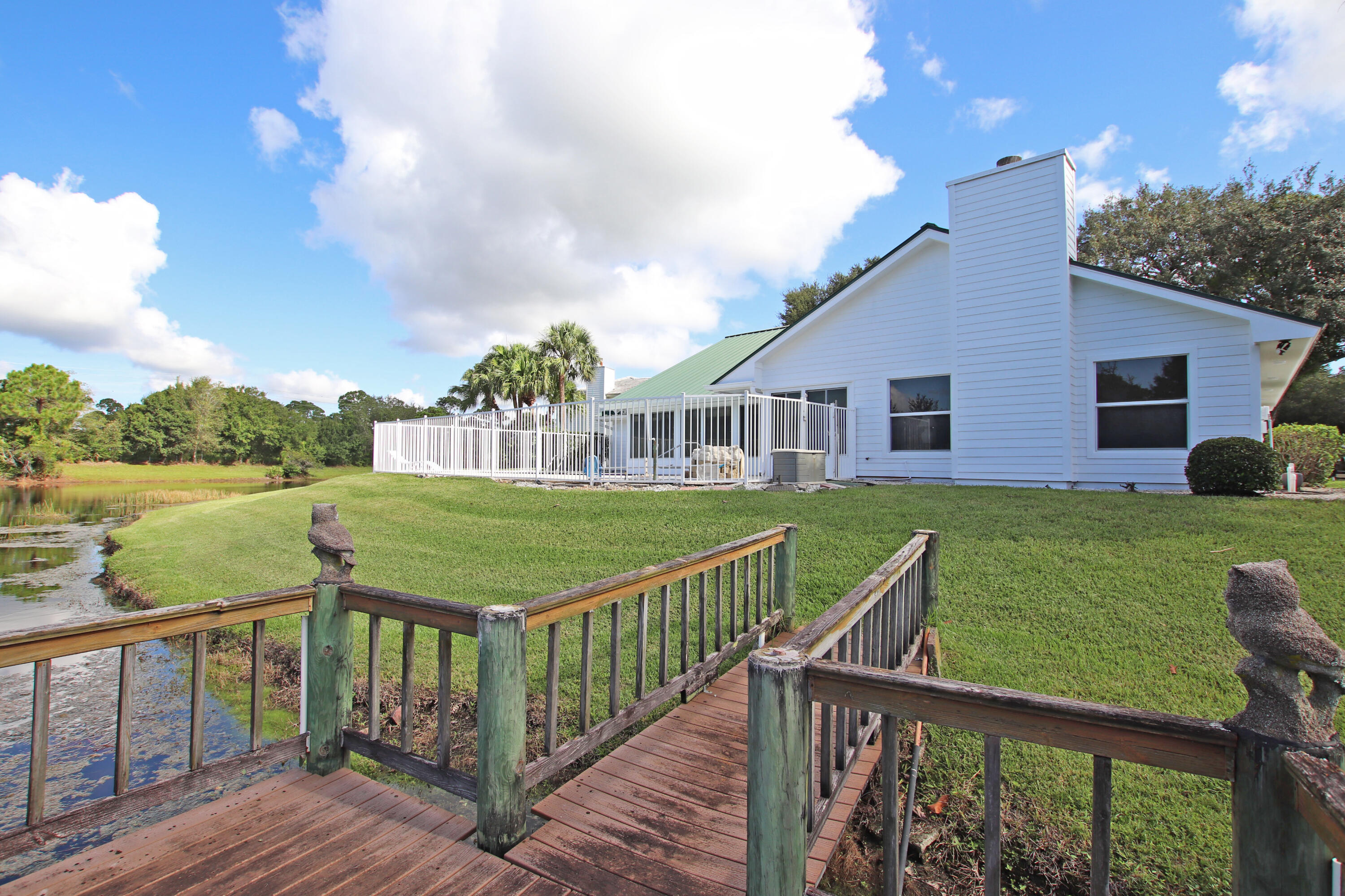 6944 Misty Lake Way Jupiter, FL 33458 - Photo 30 of 32 a view of a house with a yard and deck