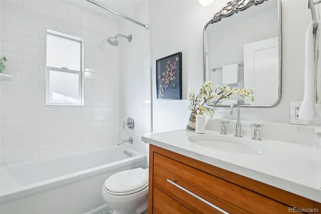 a bathroom with a sink a toilet and a bathtub