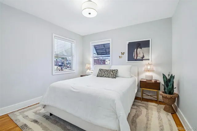 a bedroom with a bed and a painting on the wall