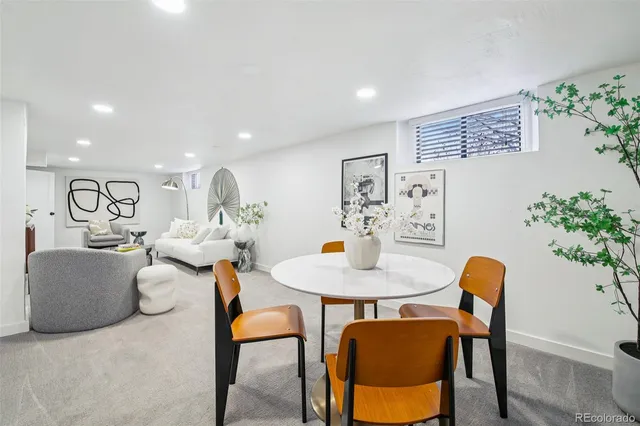 a living room with furniture and a dining table