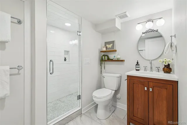 a spacious bathroom with a toilet sink and a mirror