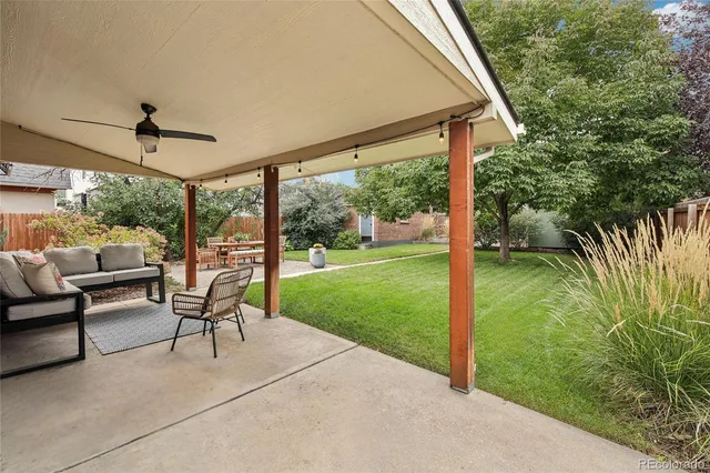 a patio with yard glass top table and chairs