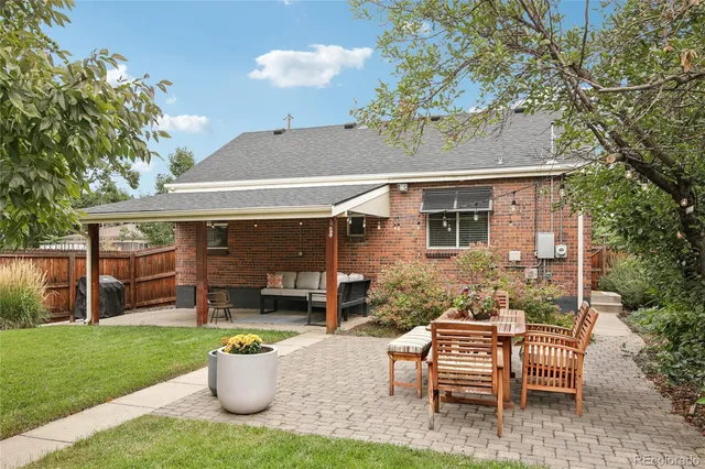 a view of a house with backyard sitting area and garden