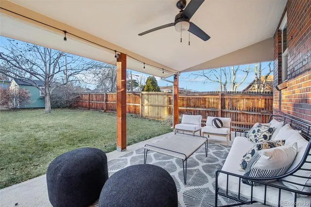 a view of a patio with a table chairs and a backyard