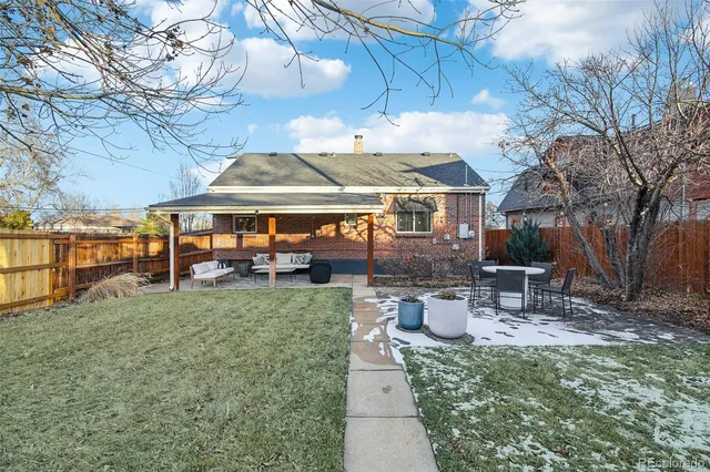 a view of a patio with table and chairs under an umbrella