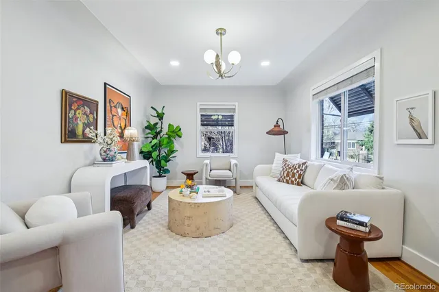 a living room with furniture and a chandelier