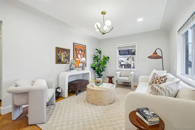 a living room with furniture and a chandelier