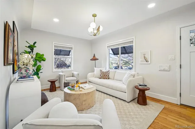 a living room with furniture and a chandelier