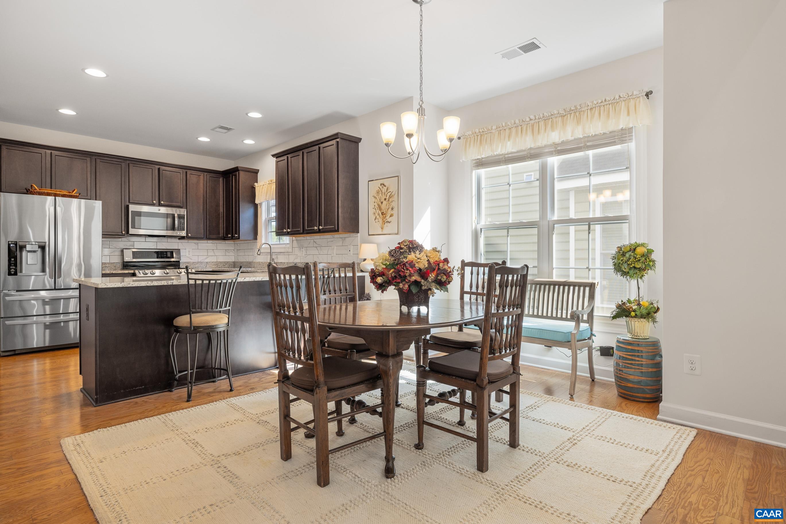 72 Spruce Drive Palmyra, VA 22963 - Photo 24 of 42 a kitchen with kitchen island granite countertop wooden cabinets a refrigerator a stove a dining table and chairs