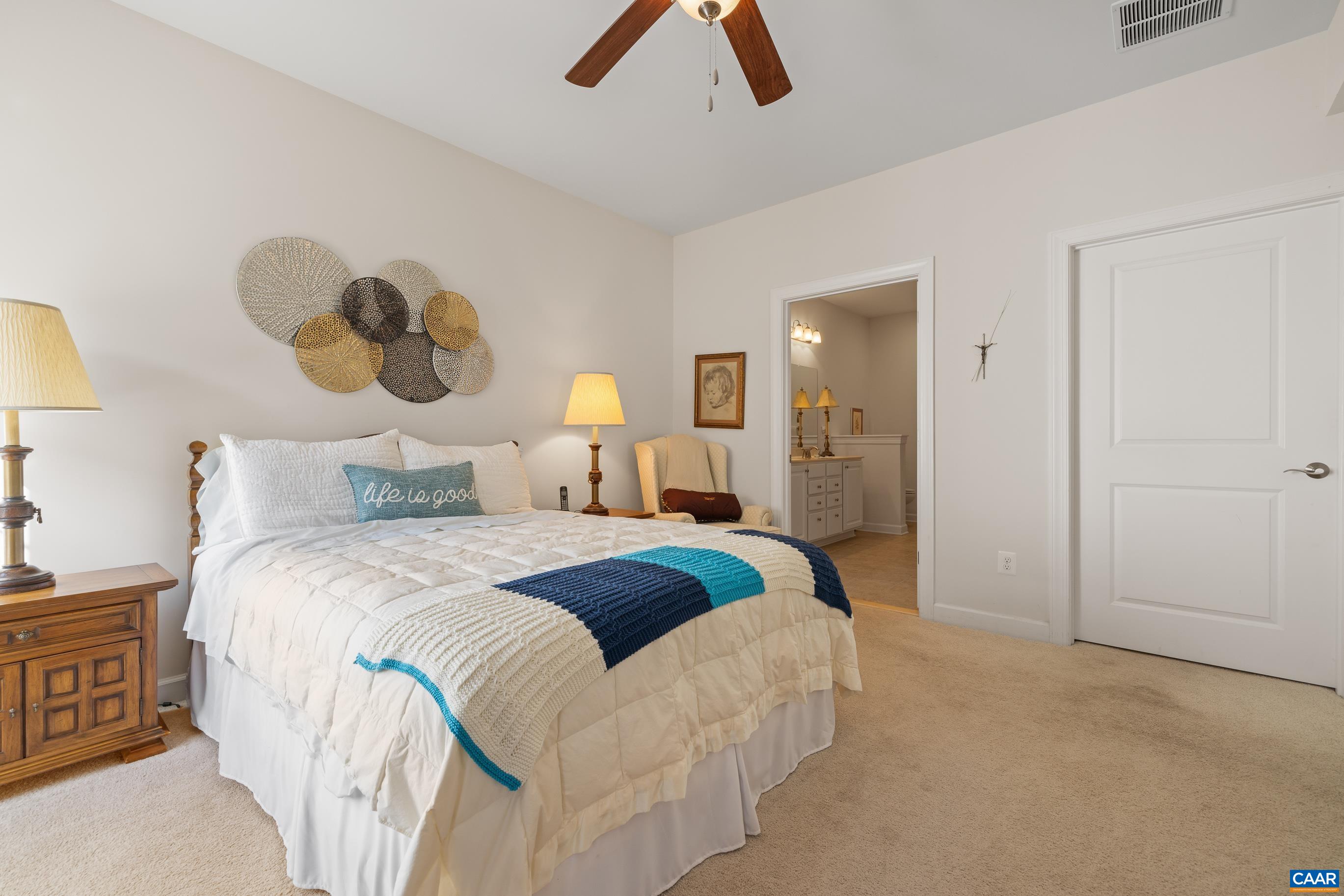 72 Spruce Drive Palmyra, VA 22963 - Photo 30 of 42 a bedroom with a bed and a chandelier