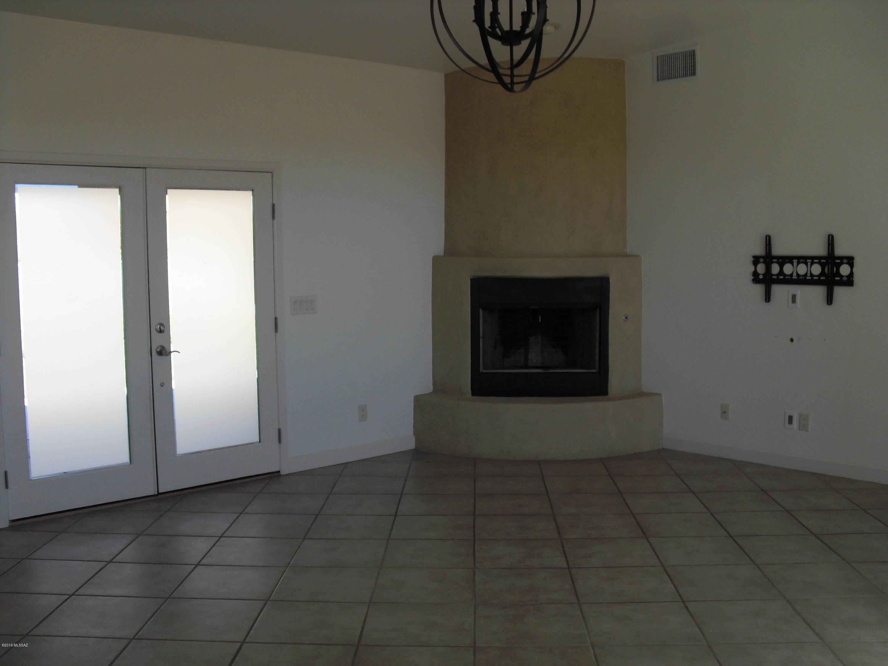 402 Hopkins Street Rio Rico, AZ 85648 - Photo 7 of 14 a view of a livingroom with an empty space and a fireplace