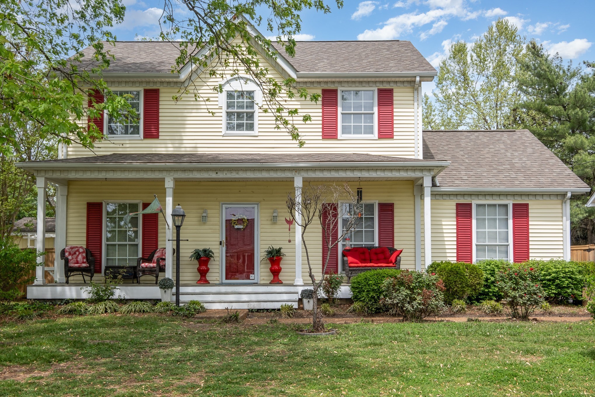 front view of a brick house with a yard