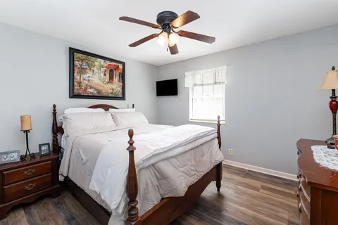 a bedroom with a bed and a chandelier