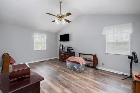 a bedroom with furniture and a window