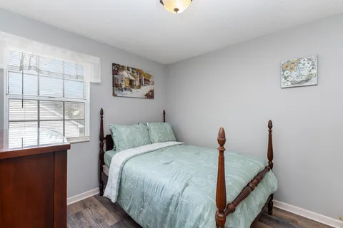 a bed room with a bed and a window