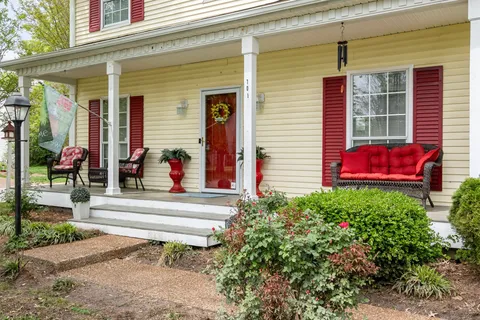 a group of people sitting in front of a house