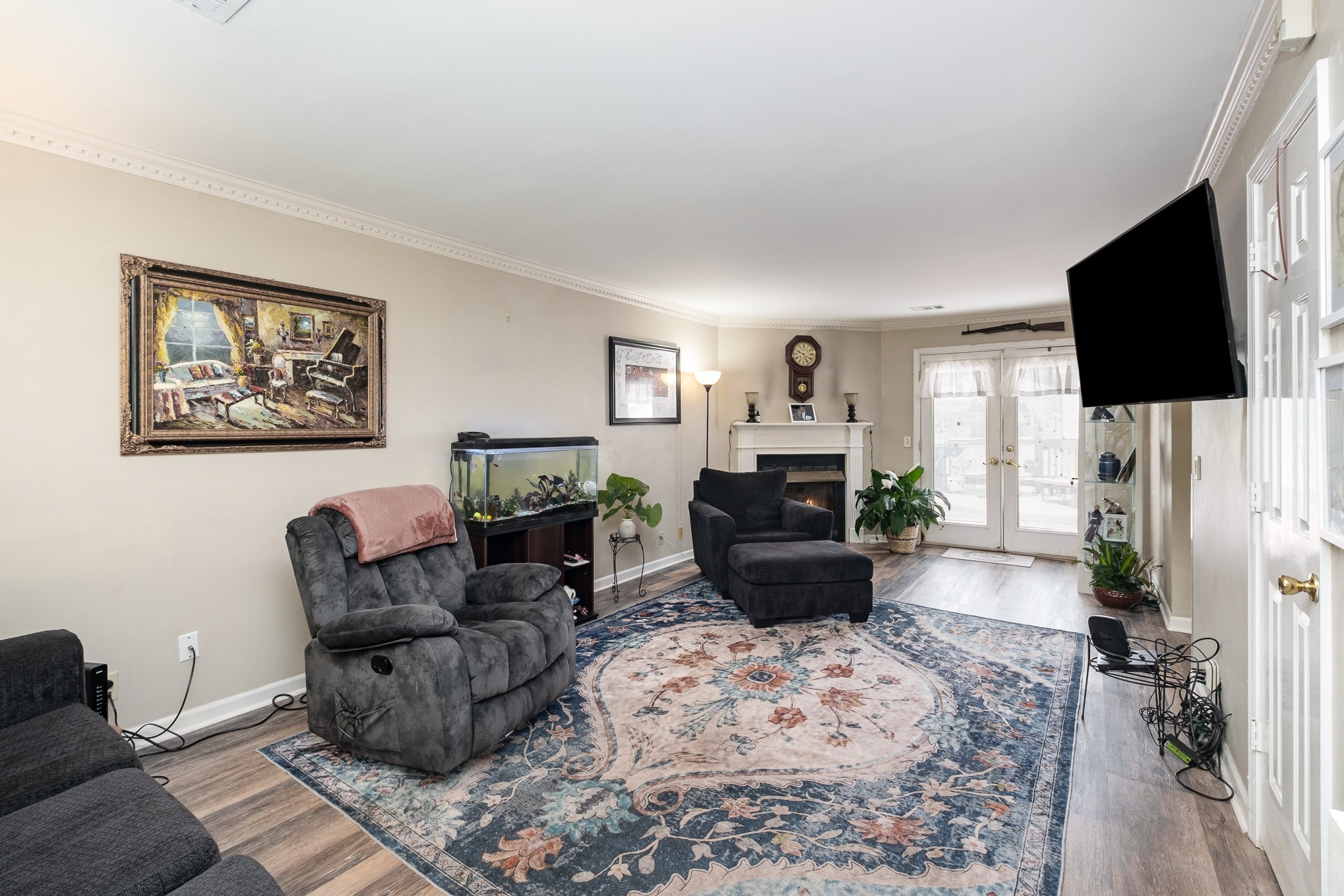 1113 Jacksons Valley Road Hermitage, TN 37076 - Photo 8 of 26 a living room with furniture a flat screen tv and a fireplace