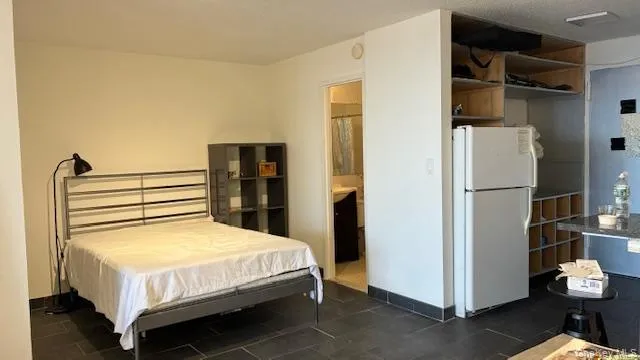 a bed sitting in a bedroom next to a cabinet