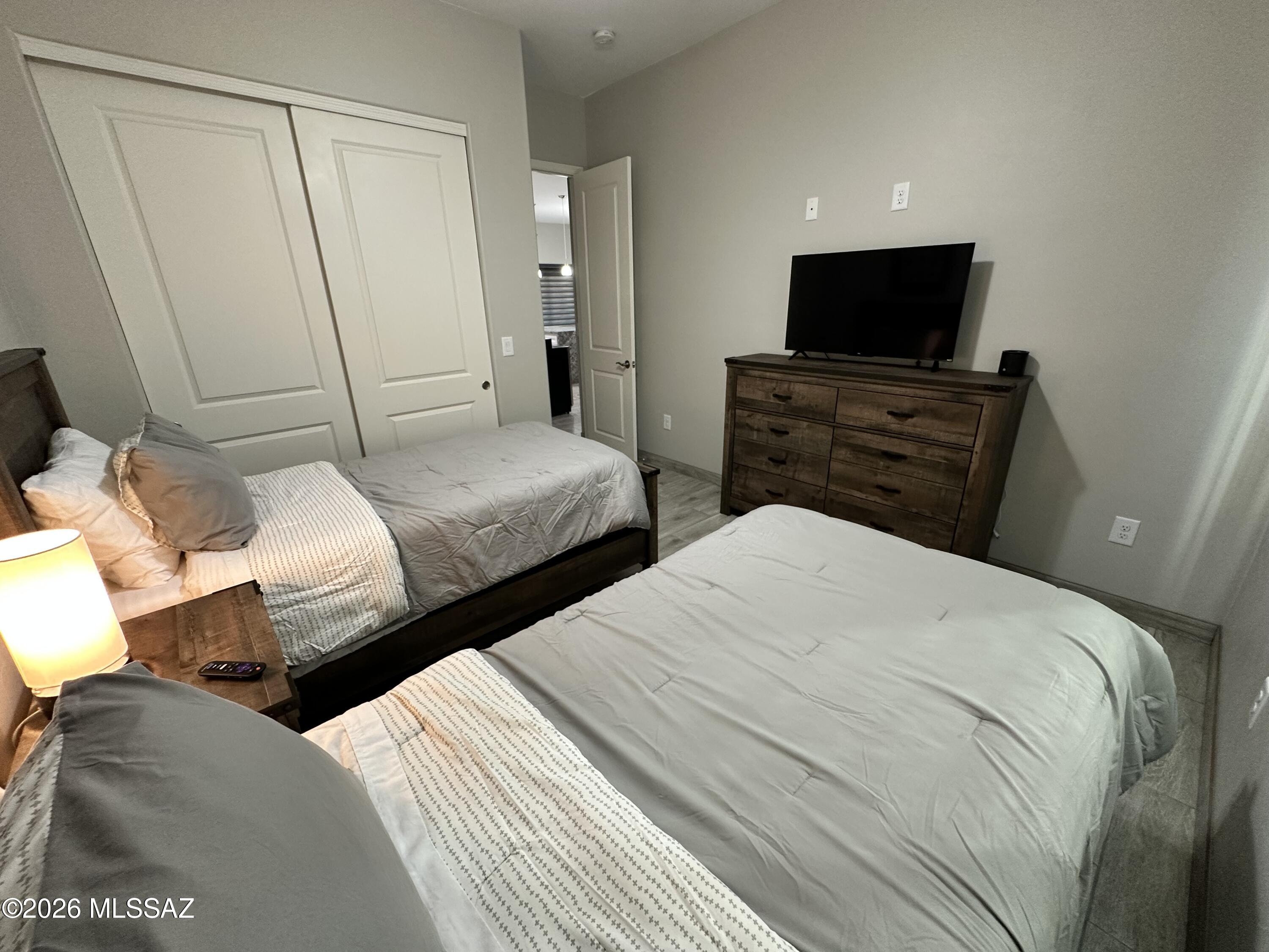 117 Ver Patria Rio Rico, AZ 85648 - Photo 11 of 28 a bedroom with two bed and a flat screen tv