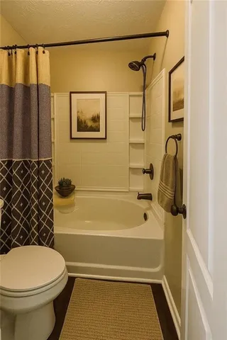 a bathroom with a toilet and a shower