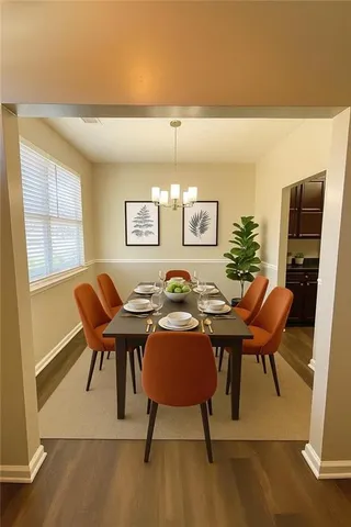a view of a dining room with furniture window and wooden floor