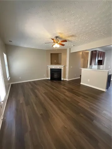 wooden floor in an empty room with a fireplace