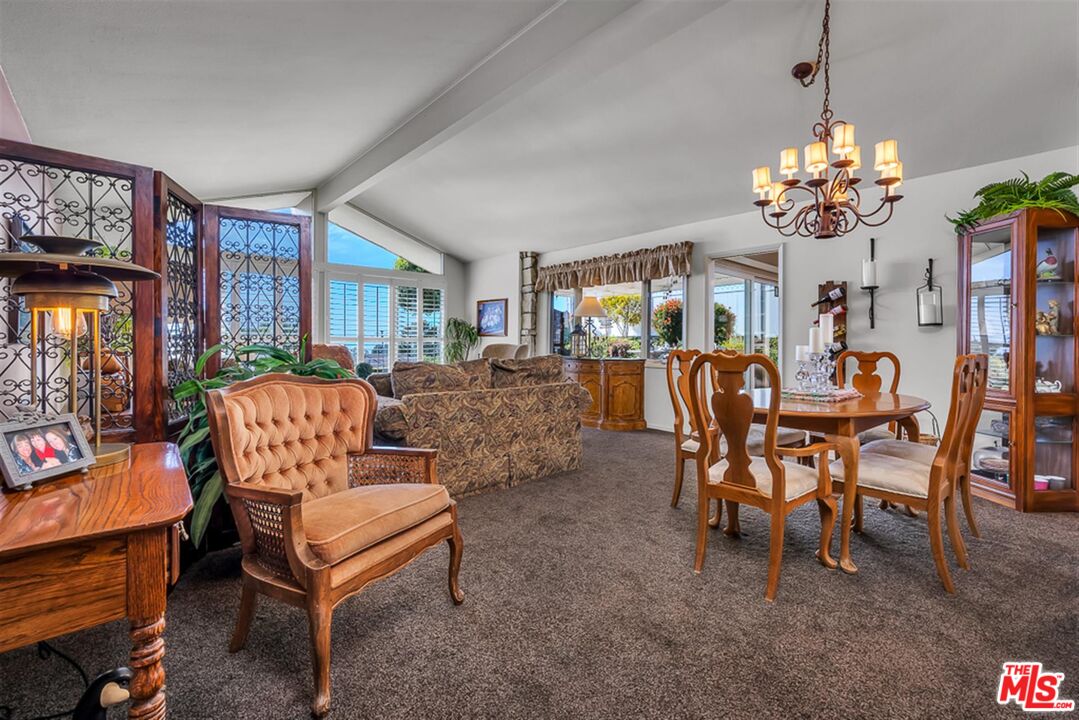 29519 Oceanport Road Rancho Palos Verdes, CA 90275 - Photo 14 of 42 a living room with furniture a chandelier and a dining table