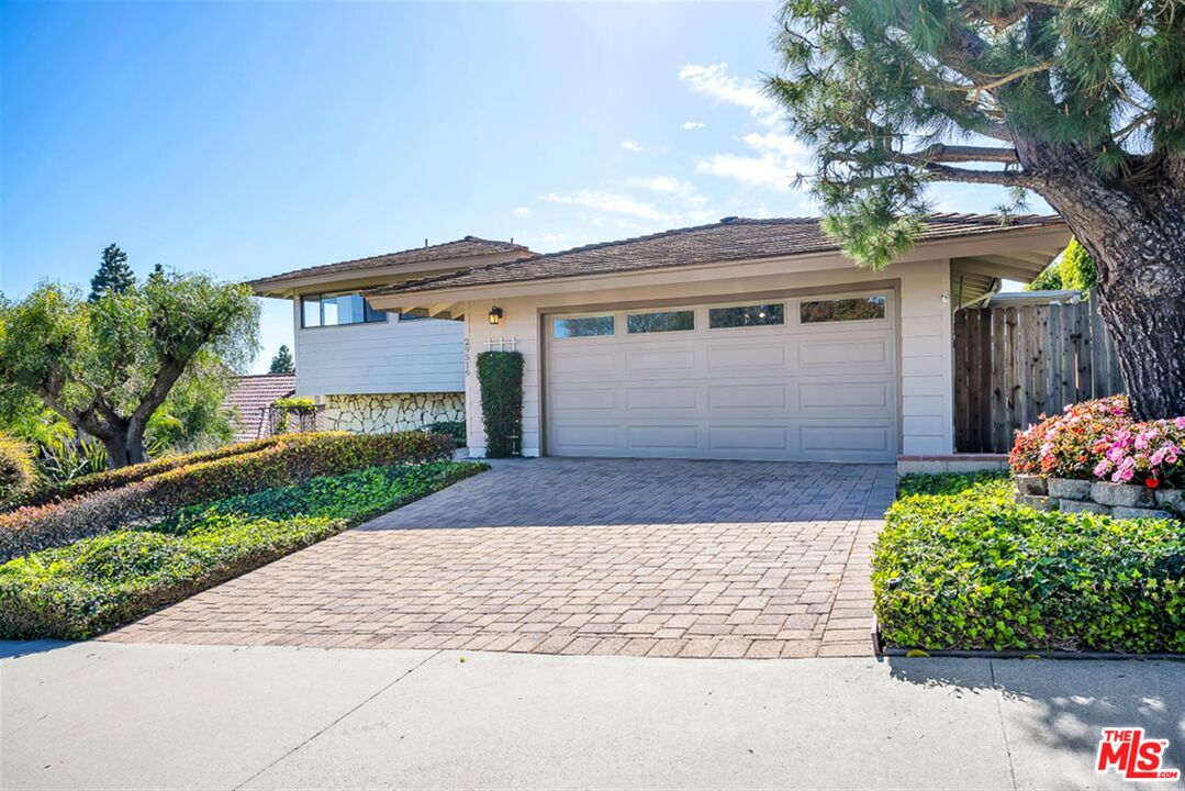 29519 Oceanport Road Rancho Palos Verdes, CA 90275 - Photo 2 of 42 a front view of a house with a yard and a garage