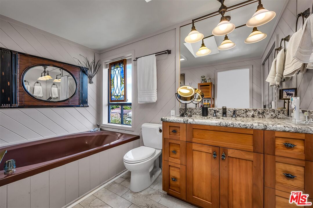29519 Oceanport Road Rancho Palos Verdes, CA 90275 - Photo 27 of 42 a bathroom with a sink a toilet and a large mirror