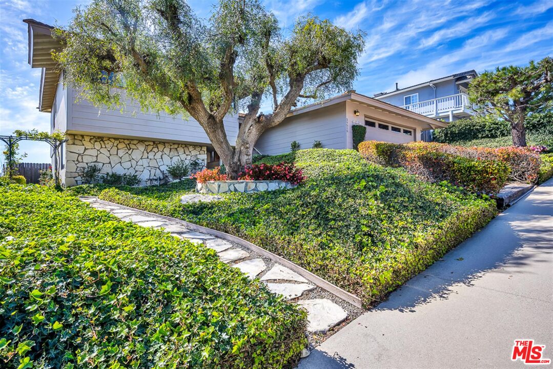 29519 Oceanport Road Rancho Palos Verdes, CA 90275 - Photo 3 of 42 a front view of a house with garden