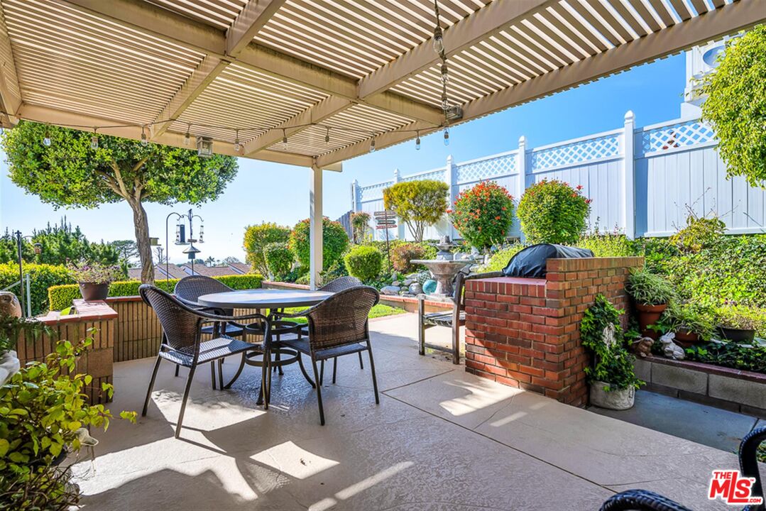 29519 Oceanport Road Rancho Palos Verdes, CA 90275 - Photo 35 of 42 a view of patio with table and chairs potted plants and palm trees