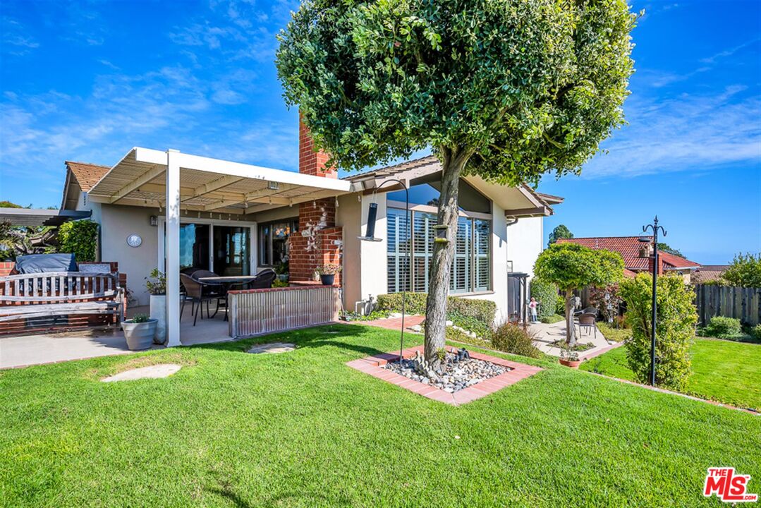 29519 Oceanport Road Rancho Palos Verdes, CA 90275 - Photo 38 of 42 a front view of a house with a yard table and chairs