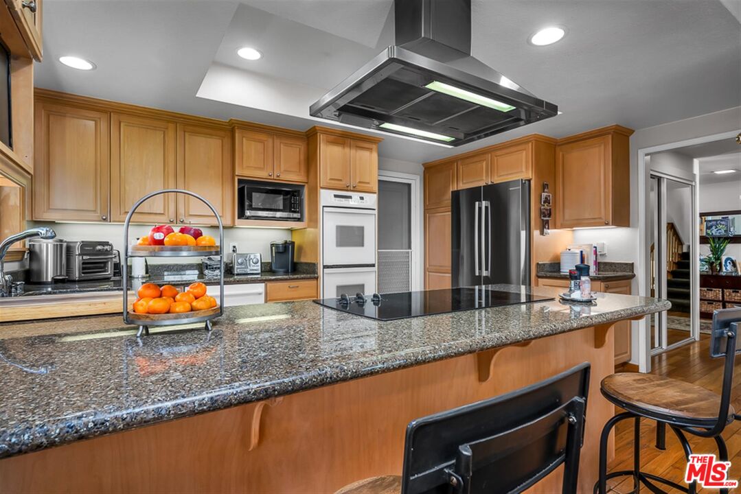 29519 Oceanport Road Rancho Palos Verdes, CA 90275 - Photo 5 of 42 a kitchen with stainless steel appliances granite countertop a sink a stove and a wooden cabinets
