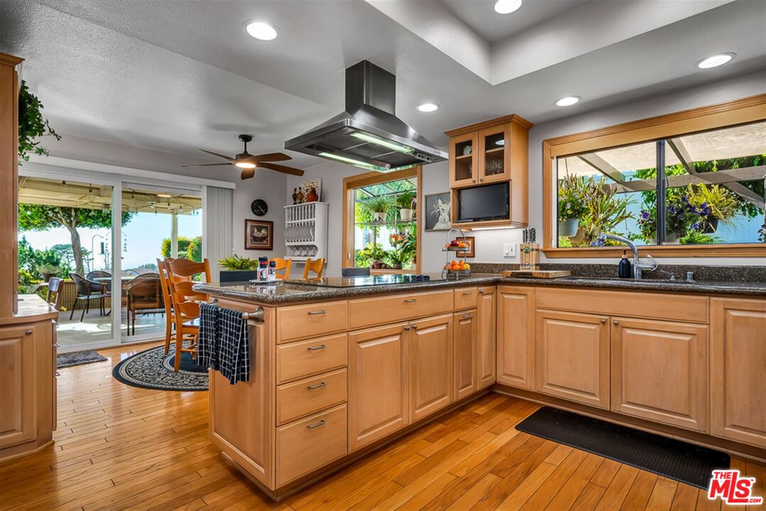 29519 Oceanport Road Rancho Palos Verdes, CA 90275 - Photo 6 of 42 a kitchen with stainless steel appliances granite countertop a stove and a wooden floors