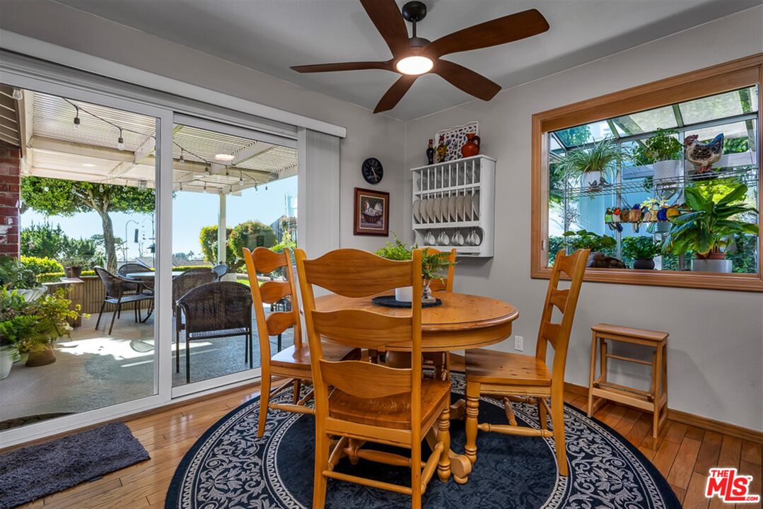 29519 Oceanport Road Rancho Palos Verdes, CA 90275 - Photo 8 of 42 a dining room with furniture a rug and a floor to ceiling window