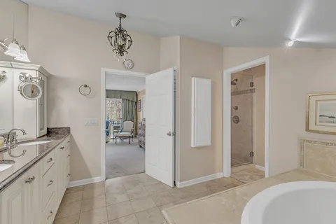 a view of a bathroom with tub shower and mirror