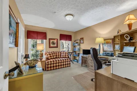 a bedroom with furniture and a window