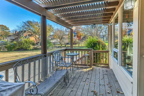 a view of a balcony with wooden floor