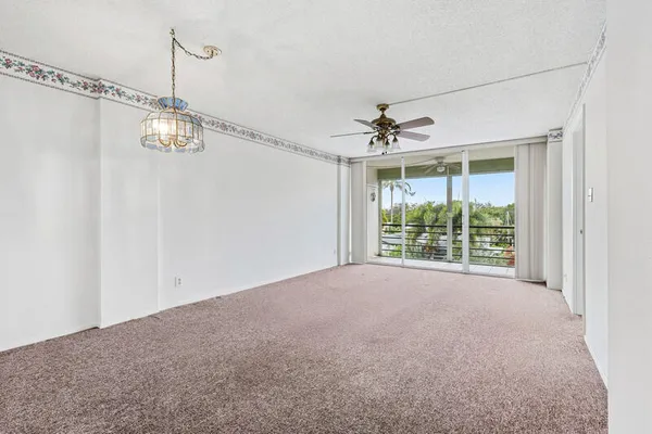 a view of a room with window and ceiling fan
