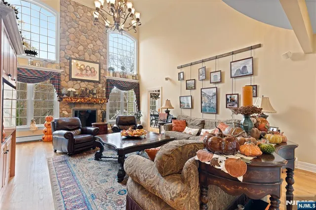 a living room with fireplace furniture and a large window