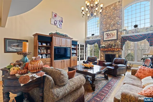 a living room with fireplace furniture and a chandelier